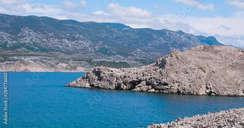 Leaving island Pag by ferry, rocky landscape