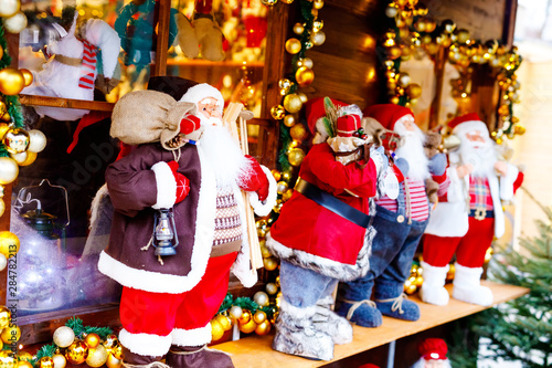 christmas market in Germany cute Santa Clause called Weihnachtsmann in German decoration, gifts, Xmas tree balls and illumination for sale