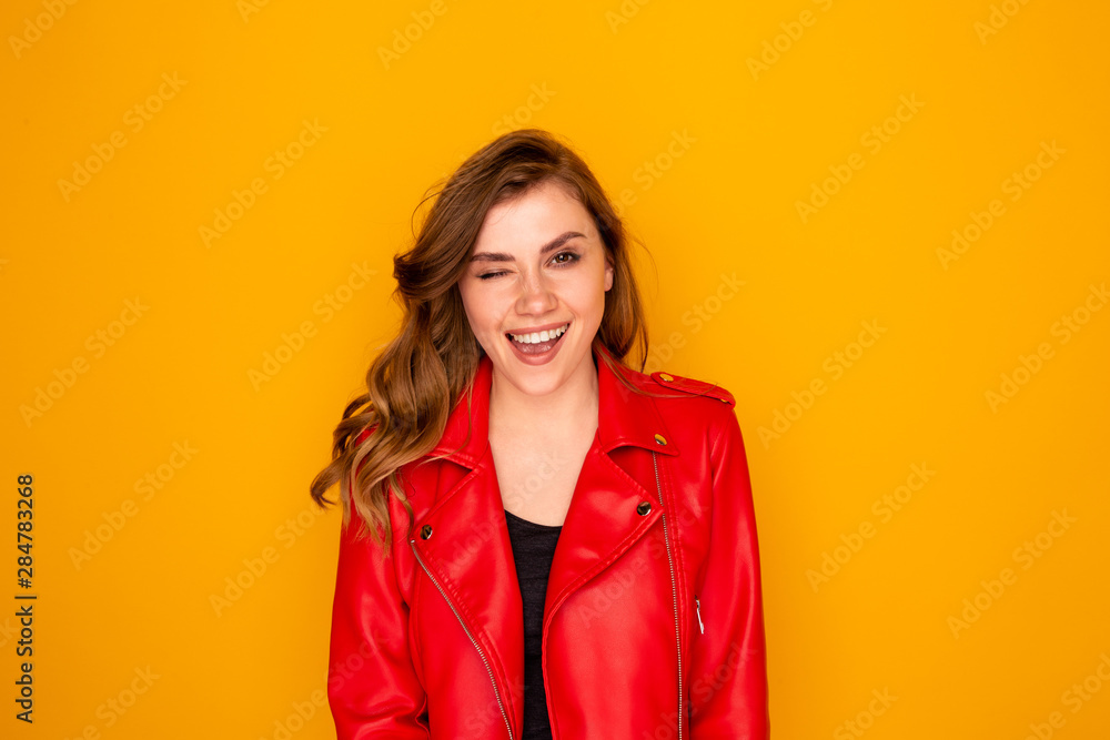 Portrait of pretty young woman in the red clothes isolated over the yellow background. Portrait of pretty young woman in the red clothes isolated over the yellow background.