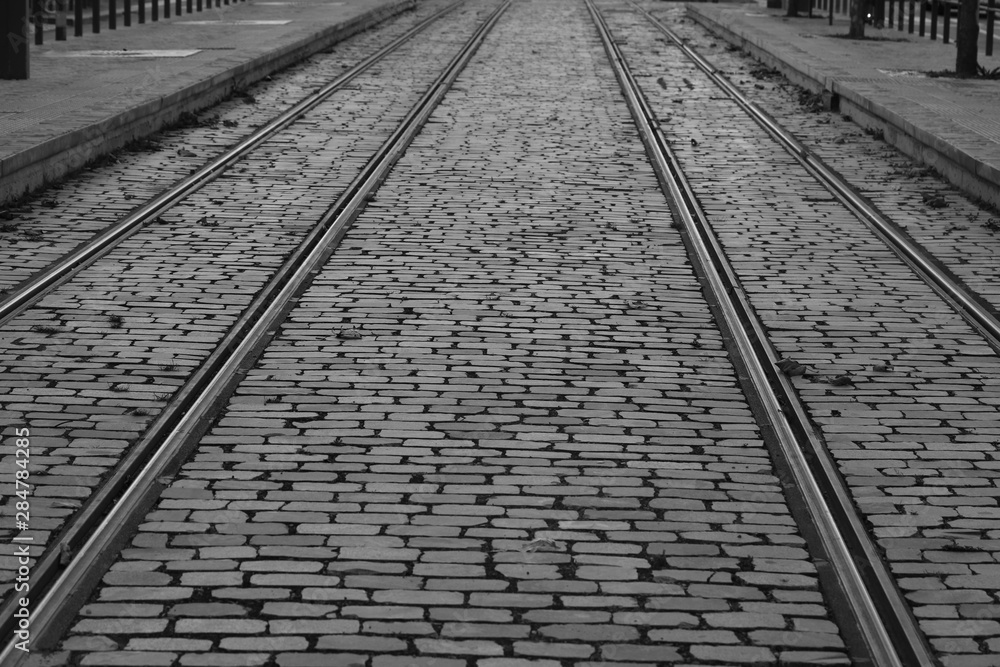 Tramlines in city black and white