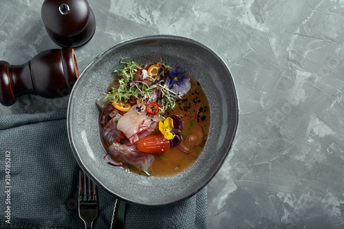 traditional peruvian food ceviche from seabass. Close-up, low key, gray background. Top view copy space