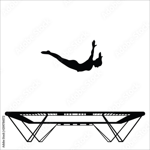 Silhouette of a woman doing front drop on a trampoline