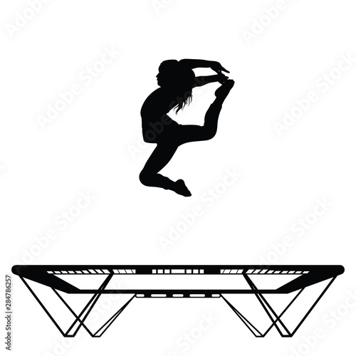 Sportswoman is doing gymnastic moves on a trampoline