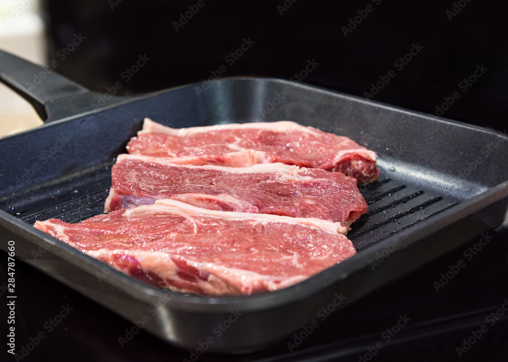 Beef fillet on grill , Beef steaks being prepared on grill , cooking meat steaks on kitchen. Beef fillet on grill , Beef steaks being prepared on grill , cooking meat steaks on kitchen.