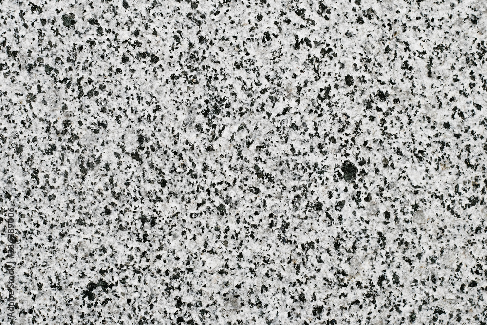 Black and white granite surface, stone motley wall. Marble quartz texture. Abstract stained grunge background, pattern.  Gray mineral pocked slab.