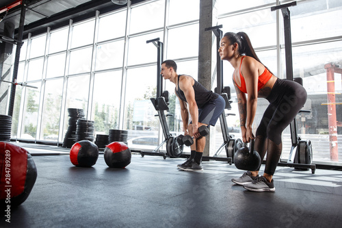 Slika na platnu A muscular athletes doing workout at the gym