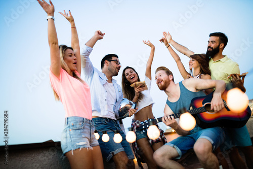 Happy group of young friends having fun in summer