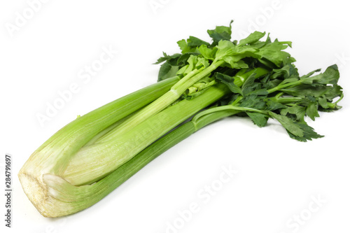 Fresh bunch of celery stalks close-up on white background