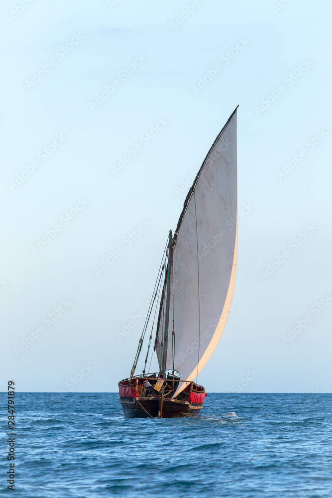 traditional dhow sailing vessel used to transport people goods and commodities heading to sea and the open ocean traditional dhow sailing vessel used to transport people goods and commodities heading to sea and the open ocean