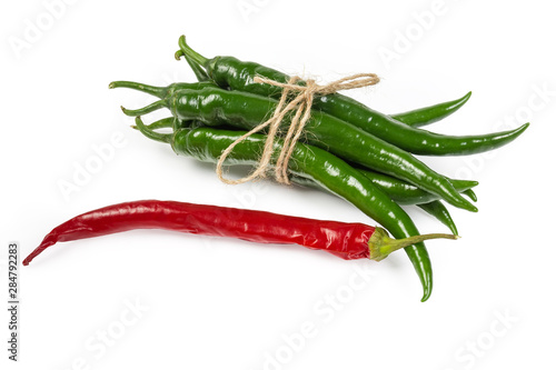 Bundle of green chili and one red chili separately