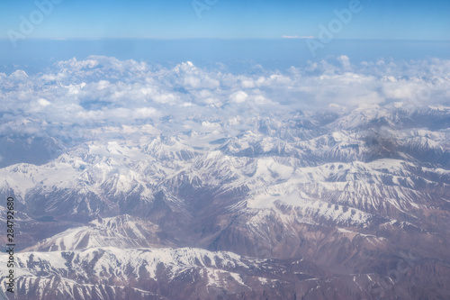 View of the Himalayas mountain through airplane window.