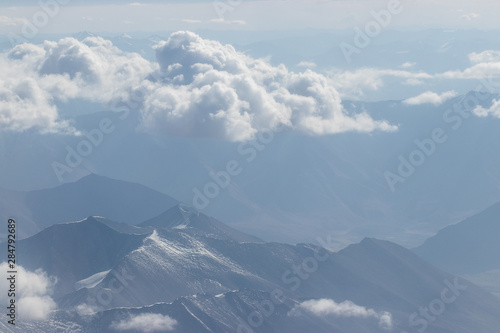 View of the Himalayas mountain through airplane window. © kannapon