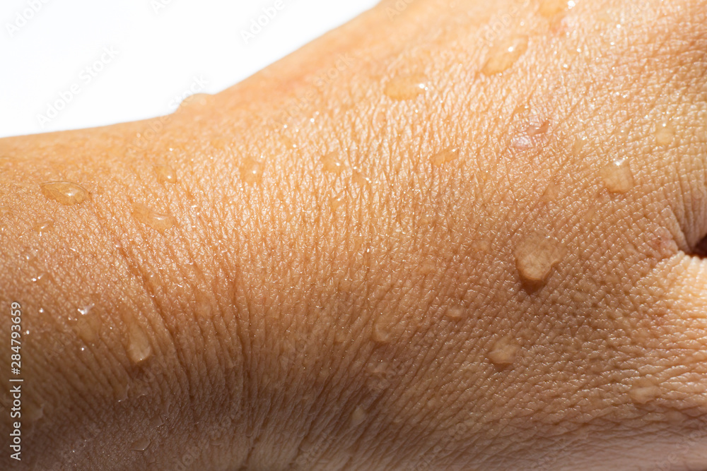 Fototapeta premium Woman's wet back hand with water drops on white acrylic background, Close up & Macro shot, Selective focus, Asian Body skin part, Relaxing Bath, Healthcare concept