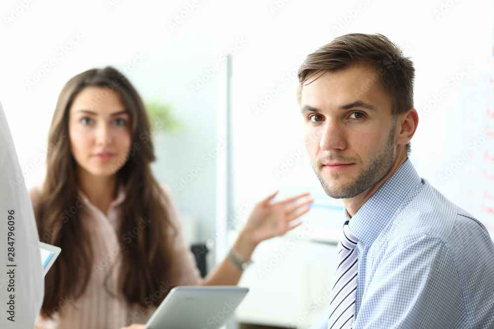 Portrait of bearded businessman sitting in office and talking with attractive female about important business contract or agreement. Biz meeting concept. Blurred background Portrait of bearded businessman sitting in office and talking with attractive female about important business contract or agreement. Biz meeting concept. Blurred background