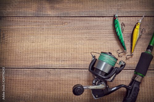 Fishing tackle on wooden surface with copy space.