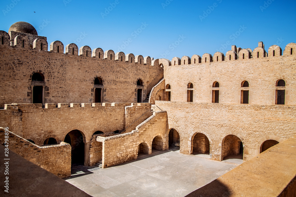 The stone walls, stairs and passages of Ribat Sousse, in the rays of the hot African sun. Tunisia. North Africa.