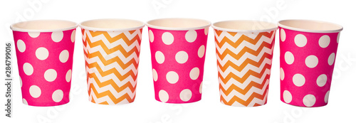 Paper disposable cups with colored pattern isolated on white background