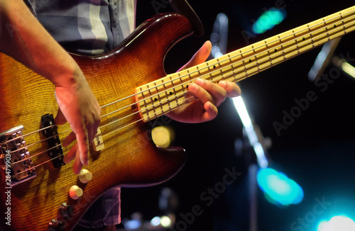 guitarist playing electrical bass guitar on a jazz concert