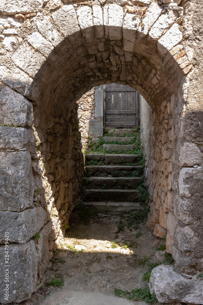 Old stone entrance to the ancient house in medieval town Beli on island Cres, Croatia