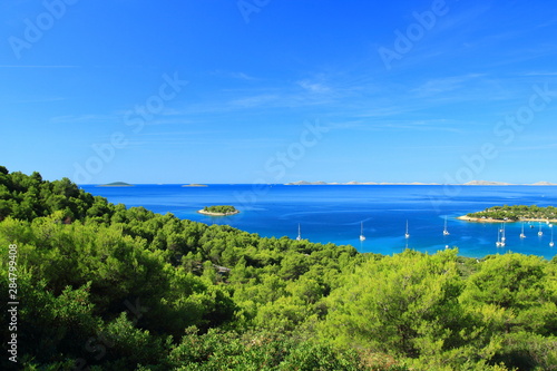 Beautiful beach and camp in Kosirina on Island Murter, Adriatic sea, Croatia. National park Kornati in background.