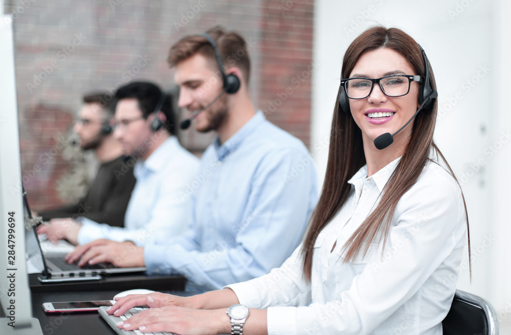 smiling call center employee sitting at his Desk smiling call center employee sitting at his Desk