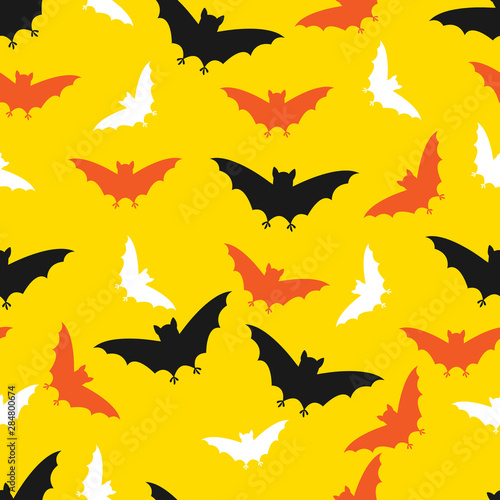 Vector seamless halloween pattern with hand draw silhouette of orange, black and white bats on yellow background for wrapping, textile or packaging