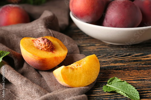 Tasty peach on wooden table