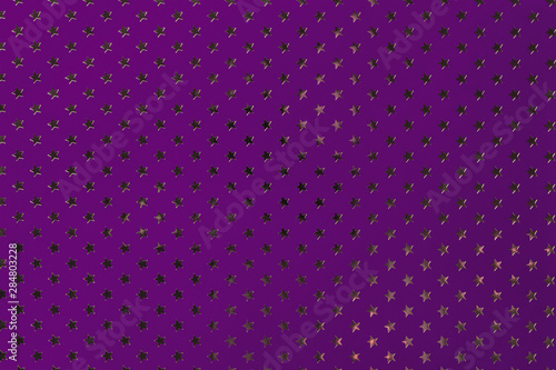 Dark purple background from metal foil paper with a golden stars pattern.