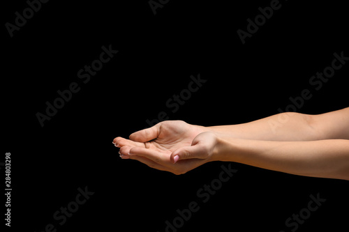 Female hands on dark background