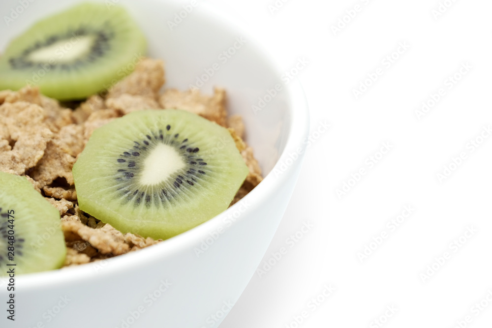 Cereal flake with green kiwi fruits in the white bowl isolated on white background Cereal flake with green kiwi fruits in the white bowl isolated on white background