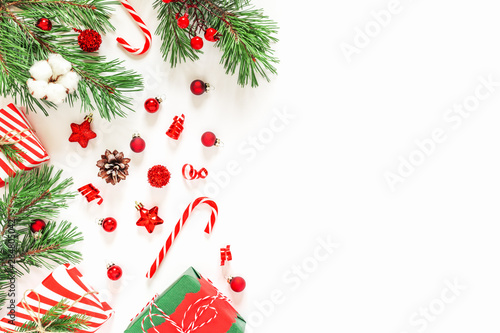 Christmas and New Year holydays composition. Fir tree branches, gifts and decor on white background. Flat lay, top view. Copy space