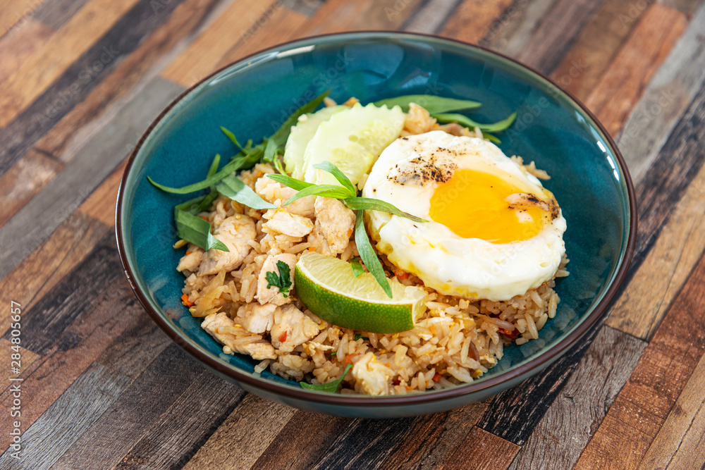 Wok rice cooked with soy sauce, vegetables and chicken pieces. Wok rice cooked with soy sauce, vegetables and chicken pieces.
