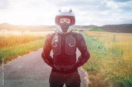Girl driver portrait, protective equipment. body armor jacket. Adventure motorbike gear. a motorcycle tour journey. Outdoor. light warm tinting, glow, freedom concept. safety first, safe driving © Sergey