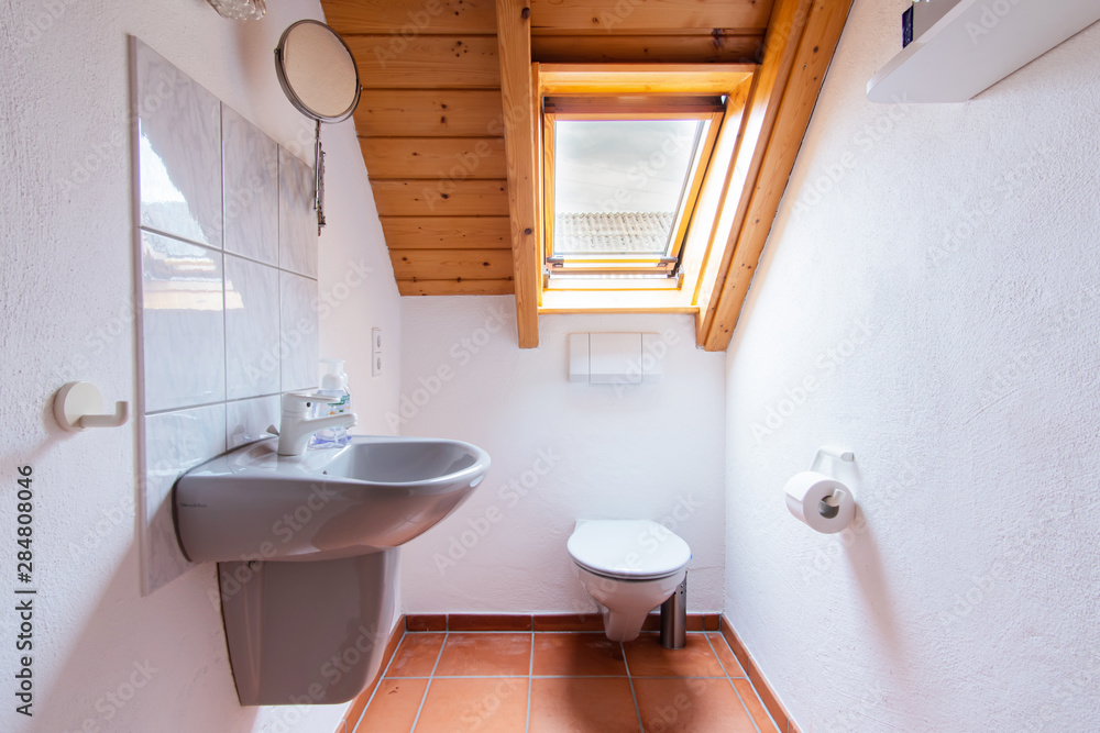 Toaleta w malym mieszkaniu. Lazienka dla gosci. Architektura miejska.  Kafelki na scianie. Stock Photo | Adobe Stock