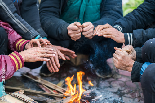 Konstfotografi Hands of rural minority people warming up around the fire during the cold weathe