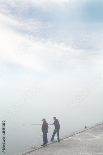 figures of the fishermen in the fog