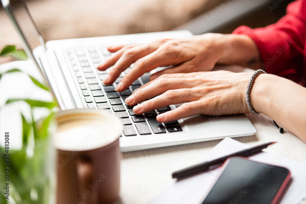 Hands of young businesswoman on laptop keypad surfing in the net Hands of young businesswoman on laptop keypad surfing in the net