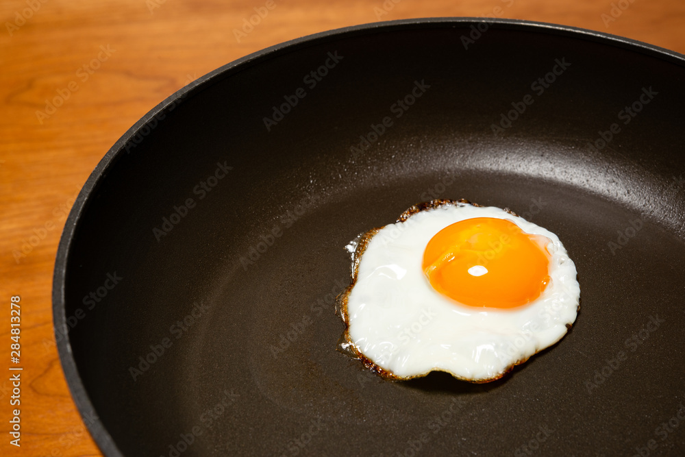 Egg frying in a pan. Egg frying in a pan.