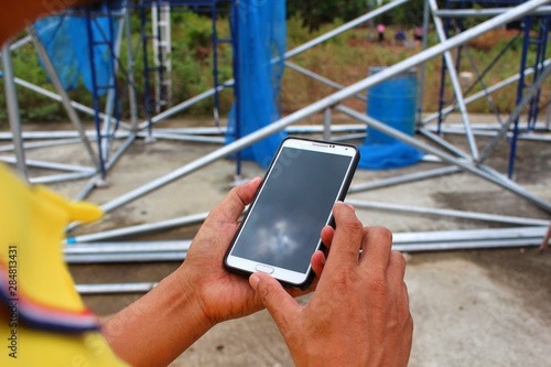 Engineers are checking work using mobile phones, taking blurred images