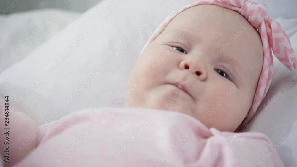 selective focus of infant gesturing in bed selective focus of infant gesturing in bed
