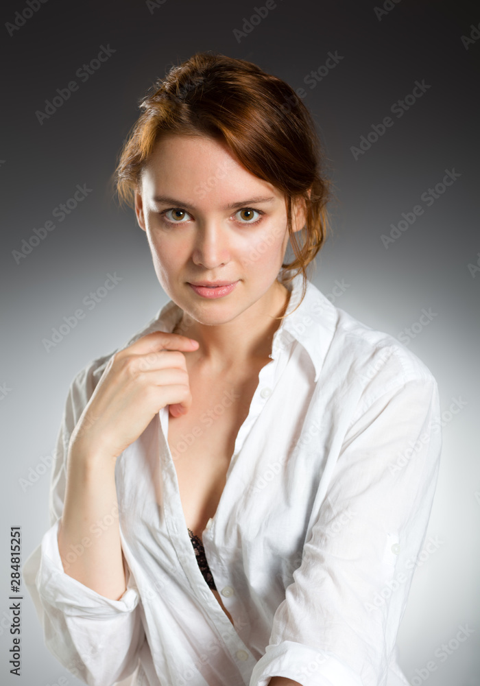 Beauty fashion portrait. Young woman on grey wall background. Beauty fashion portrait. Young woman on grey wall background.