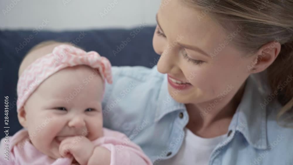 selective focus of happy mother looking at infant 