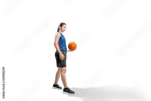 Asian woman basketball player holding the ball