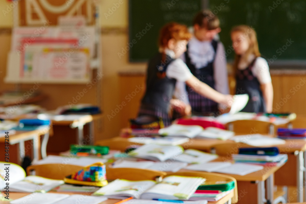 A group of primary school students communicate during the break. Background image. A group of primary school students communicate during the break. Background image.