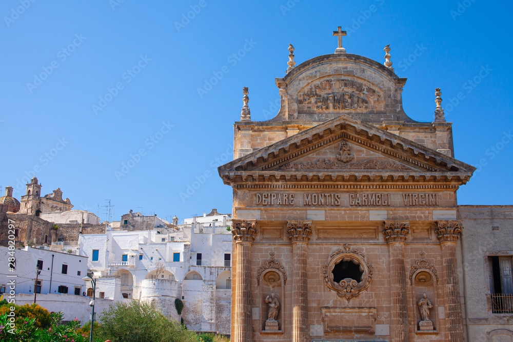 Confraternity of Carmine church in the white city Ostuni, famous tourist destination in Brindisi province, Region Apulia(Puglia), southern Italy. Clear blue sky