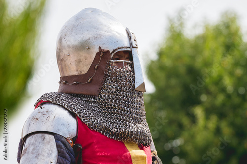 Portrait of knight in helmet on blurred background_