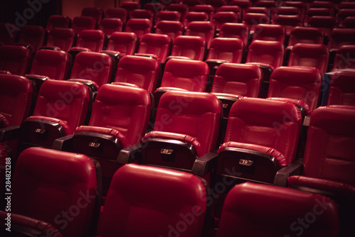 Red leather movie seats with lights dimmed