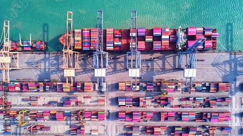 4K Timelapse of modern industrial port with containers from top view or aerial view. It is an import and export cargo port where is a part of shipping dock.Singapore photo