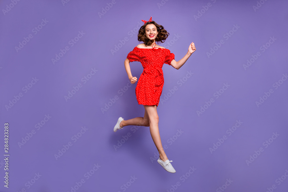Full body photo of pretty jumping high lady rushing sale wear red dress isolated purple background