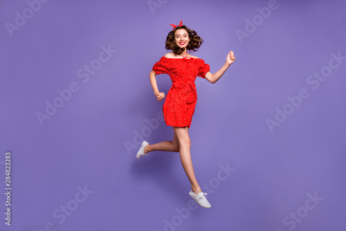 Full body photo of pretty jumping high lady rushing sale wear red dress isolated purple background